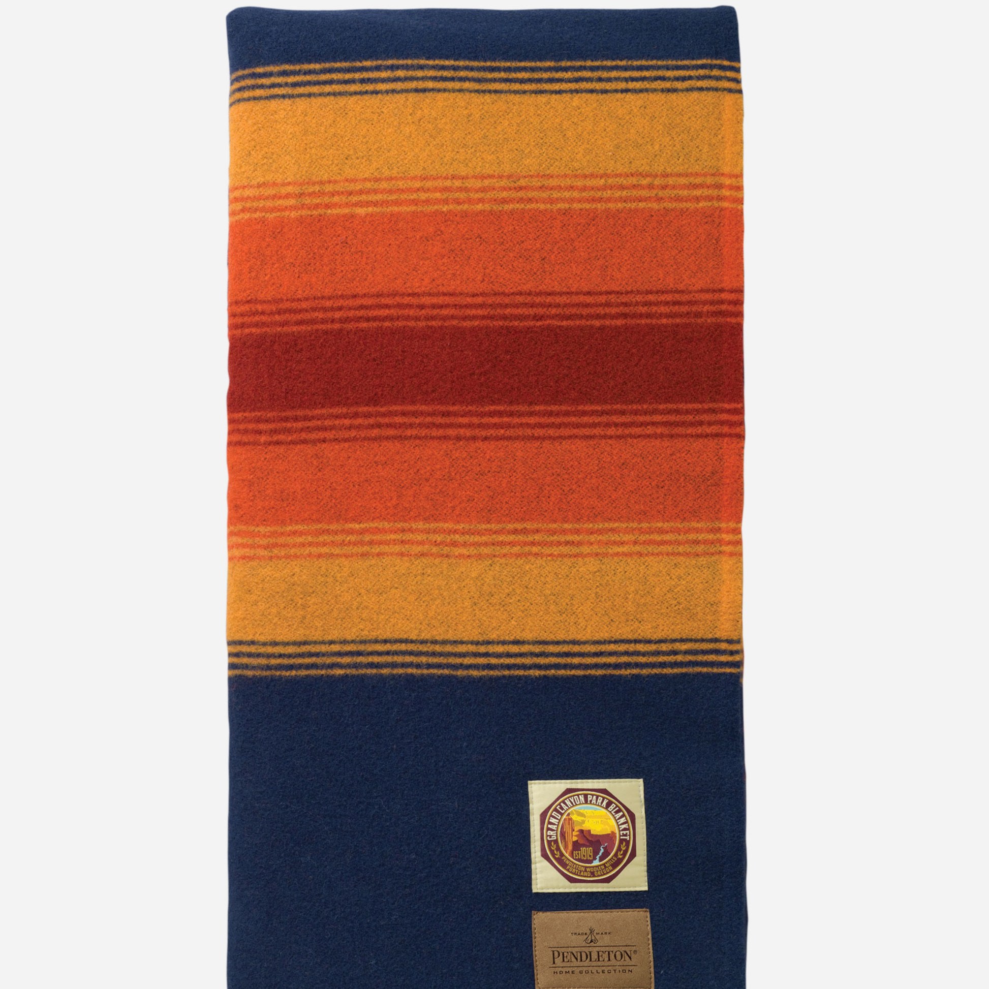 A Pendleton wool scarf with a striped pattern in navy blue, orange, red, and yellow, featuring a brand patch and label near the bottom.