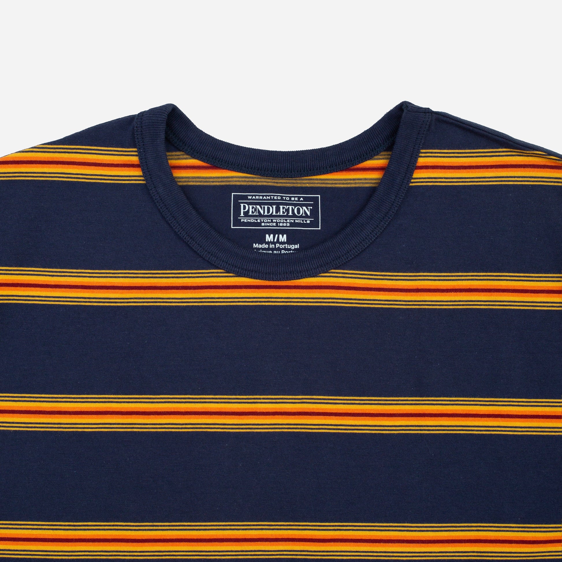 Close-up of a Pendleton crewneck t-shirt featuring horizontal stripes in navy blue, orange, and yellow, with the brand label visible inside the collar.