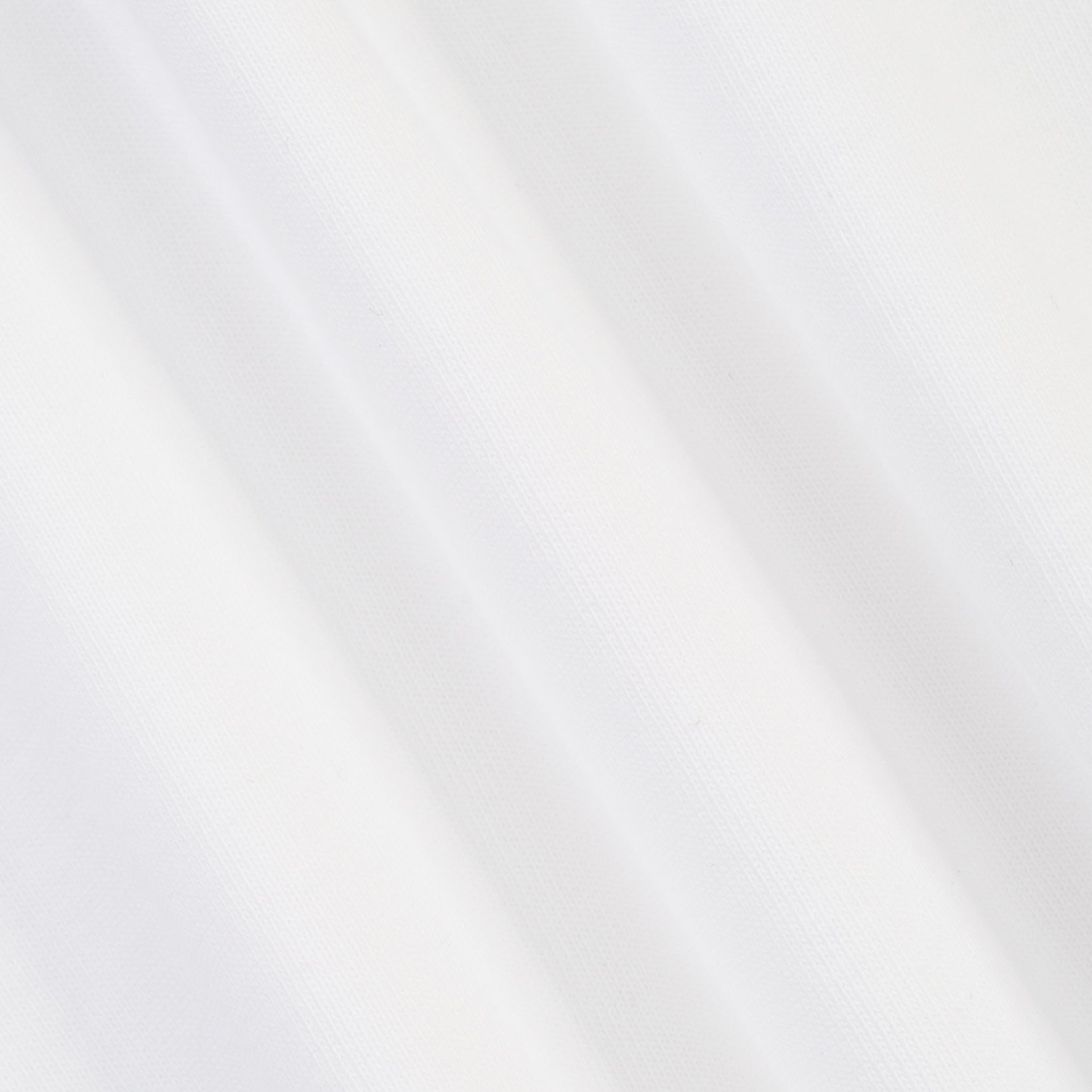 A close-up of a white textured fabric with soft diagonal folds and a fine woven pattern.